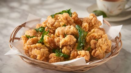 Basket of golden fried cauliflower florets garnished with parsley on a table