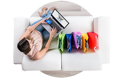 A woman is laying on a couch using a laptop computer.