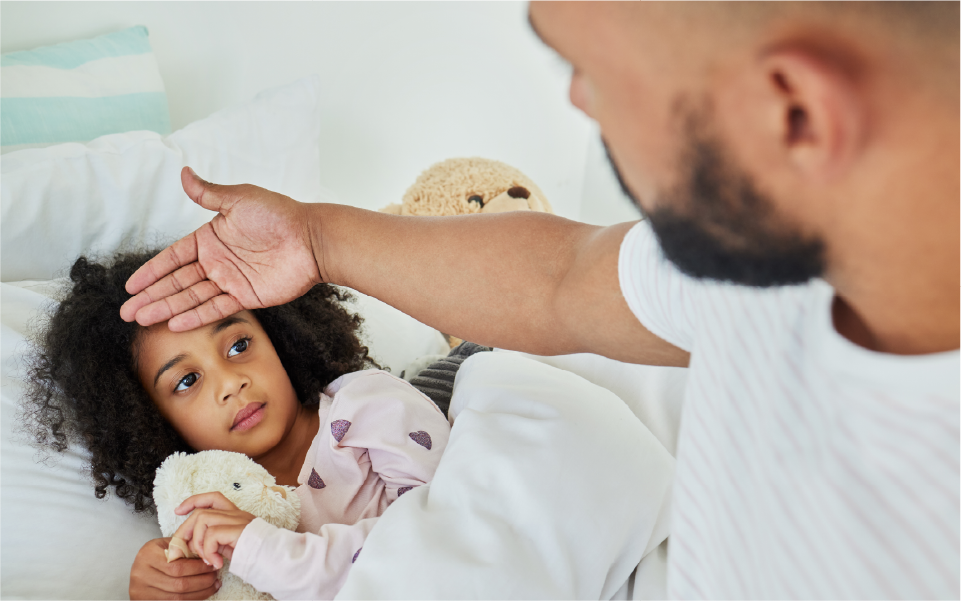 Doctor examining a crying baby while a parent holds them outdoors on a porch