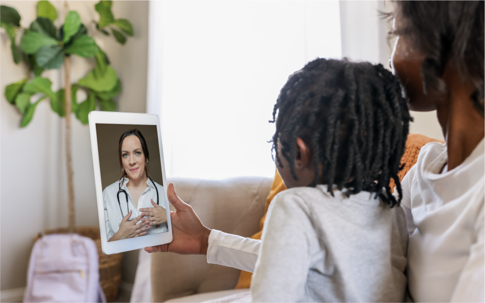 Healthcare worker in blue gloves checks a child’s arm while seated in a bright clinic.