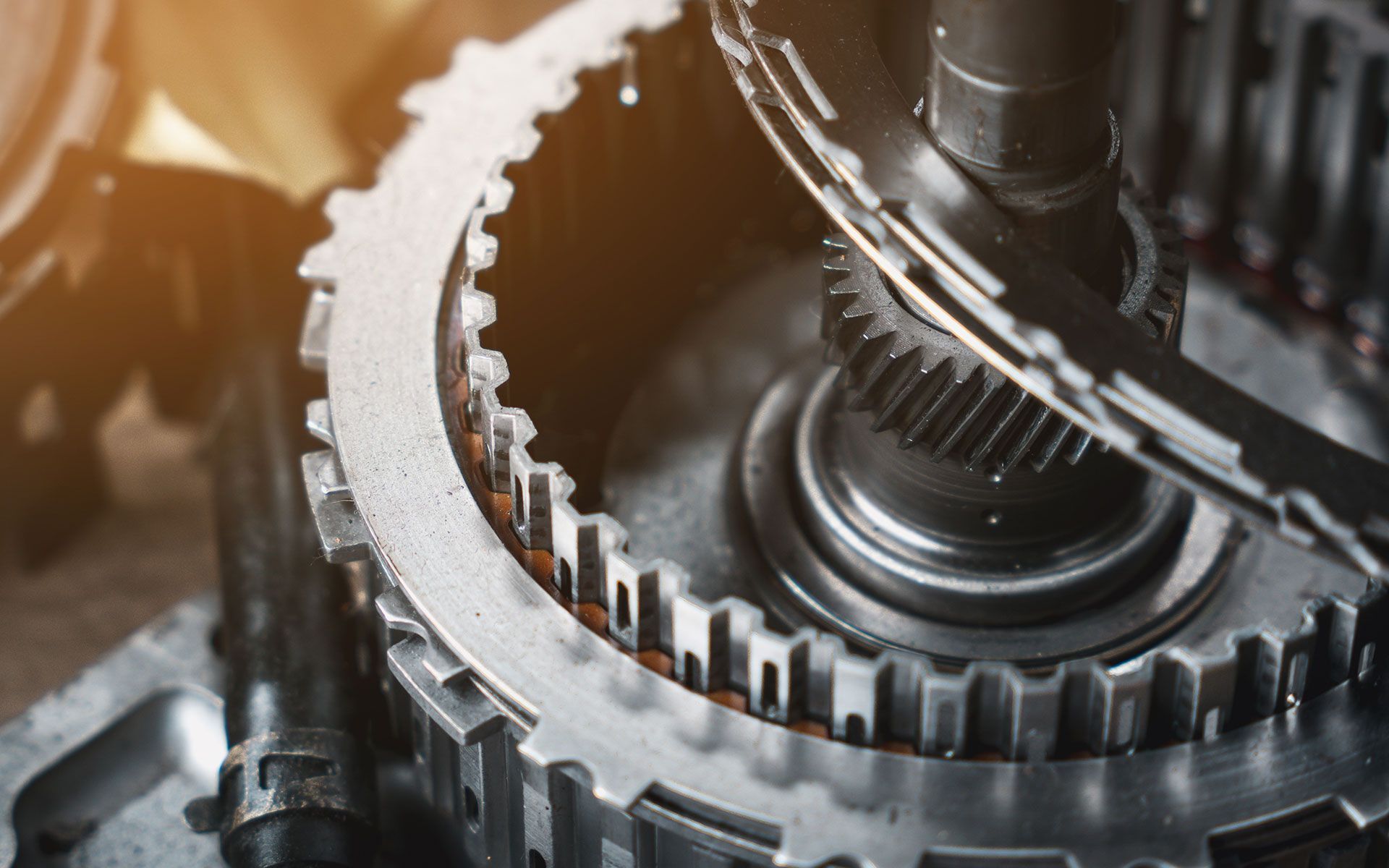 Close-up of gears and mechanical components of an engine transmission, metallic and complex.