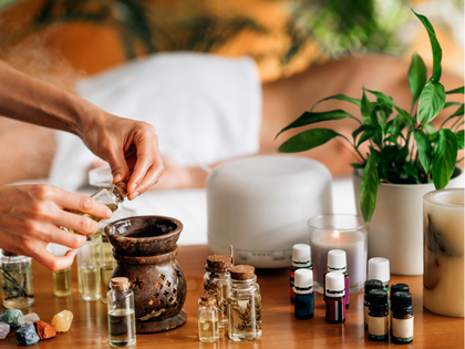 Massage therapist pressing hands into a client’s bare back during a spa treatment