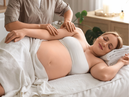 Person receiving a back massage with a handheld device on a spa table