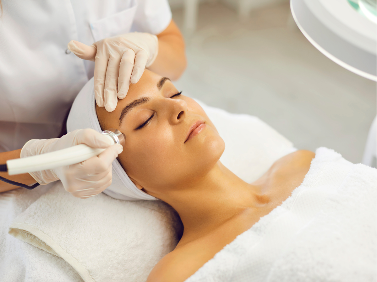 Person receiving a back massage with a handheld device on a spa table Person receiving a back massage with a handheld device on a spa table