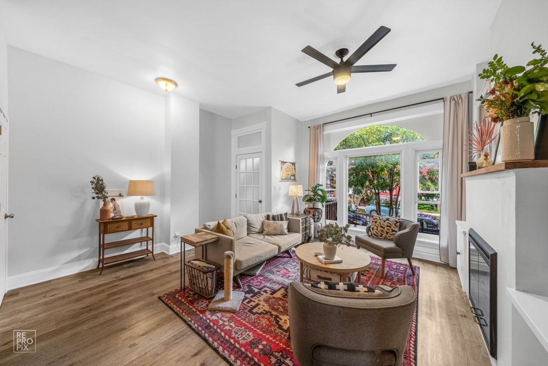 A living room filled with furniture and a ceiling fan.