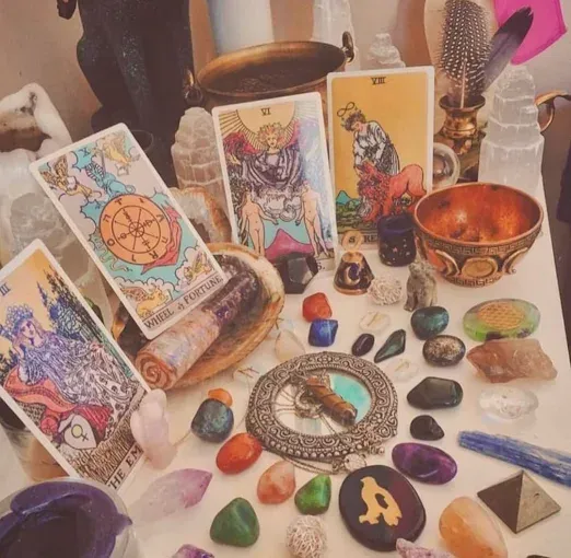 There are tarot cards and candles on the table.