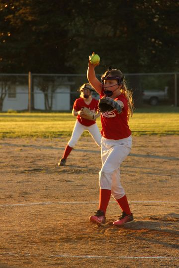 Baseball on a dark surface, with visible stitching.