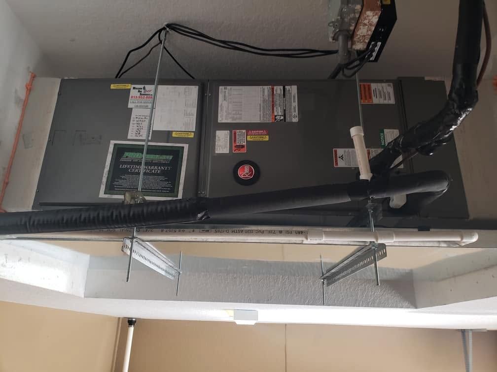 Two HVAC ceiling units above a lighted hallway opening