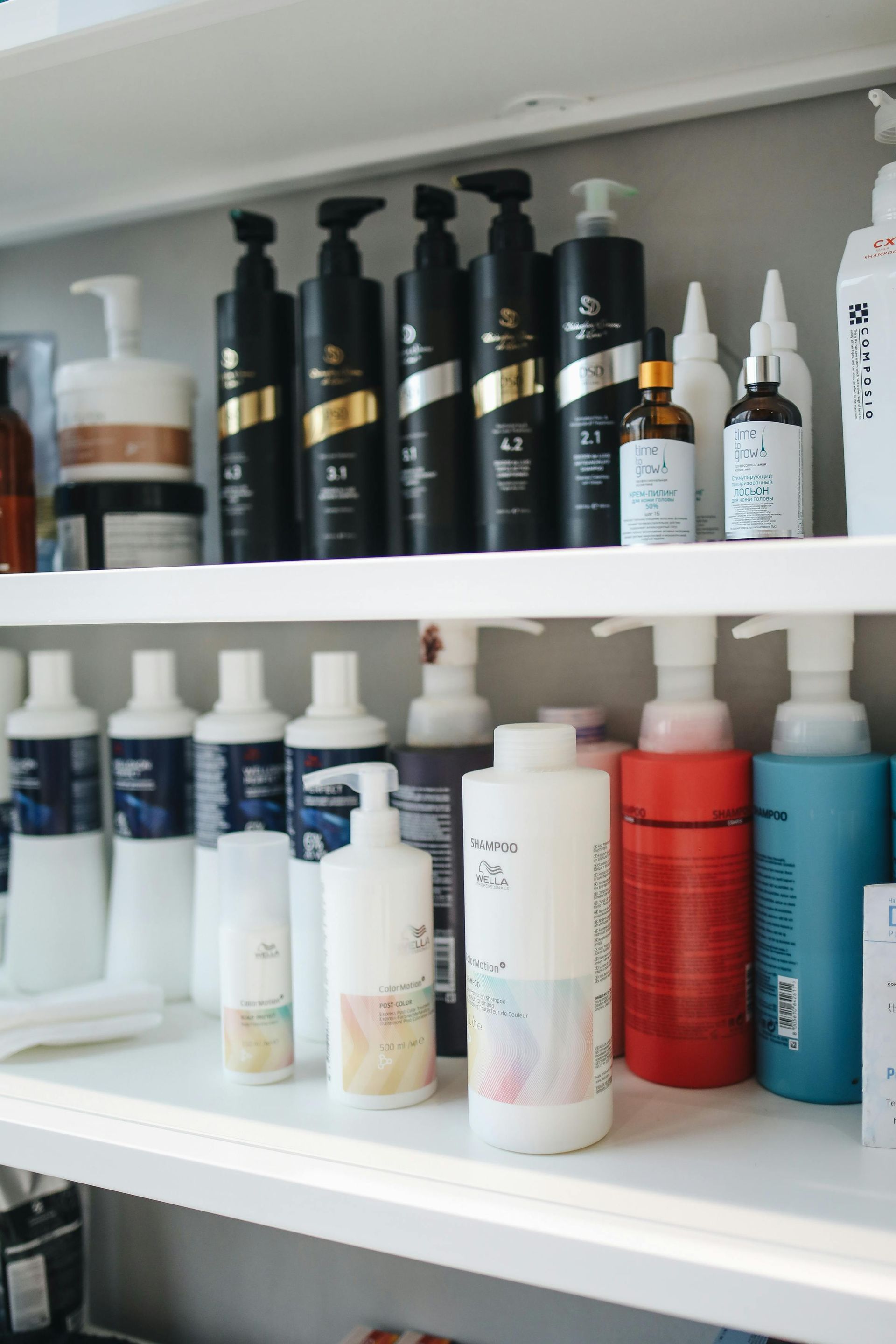 Shelves stocked with assorted bottles and containers of hair or skincare products