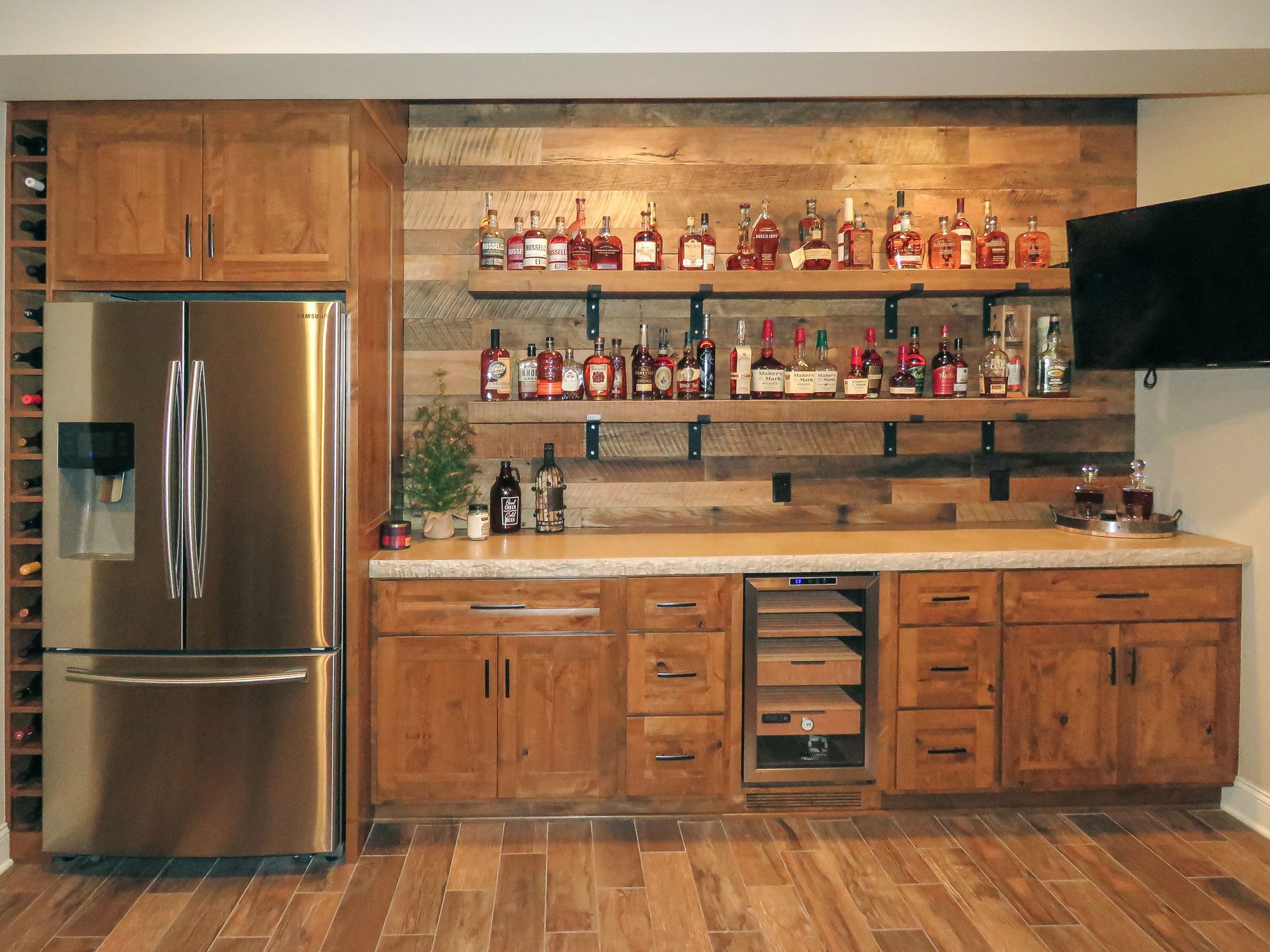 Custom stained wood beverage center with under-cabinet fridge.
