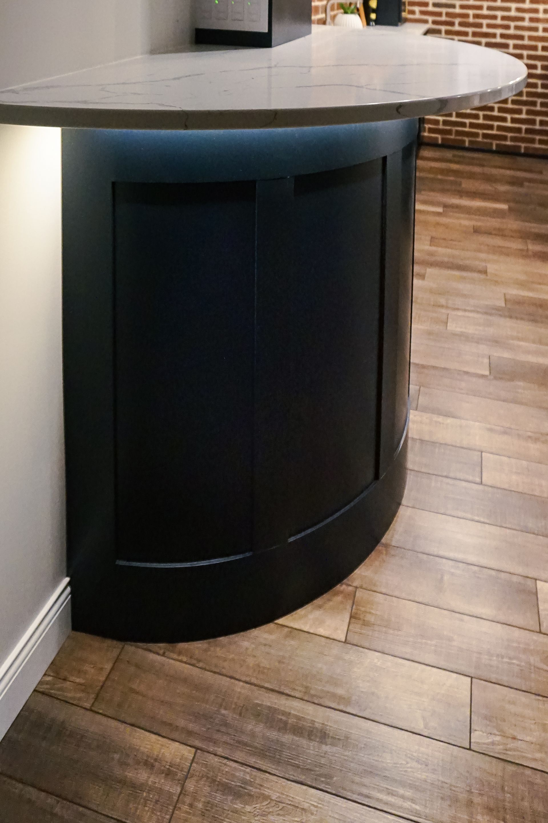 Custom black painted, curved wood beverage and bar cabinet with under the counter lighting.