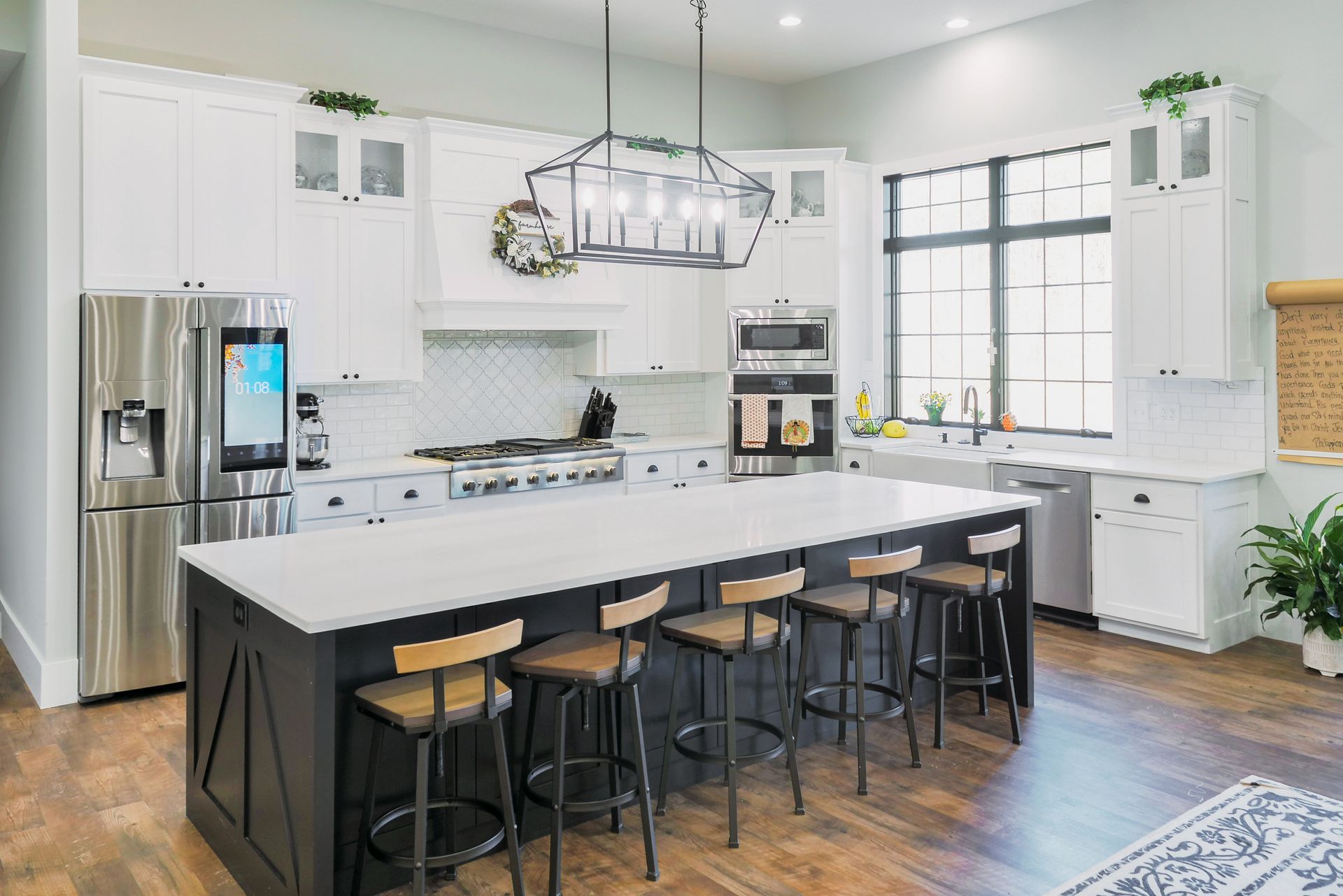 Custom, modern painted kitchen cabinets and island, stainless appliances.
