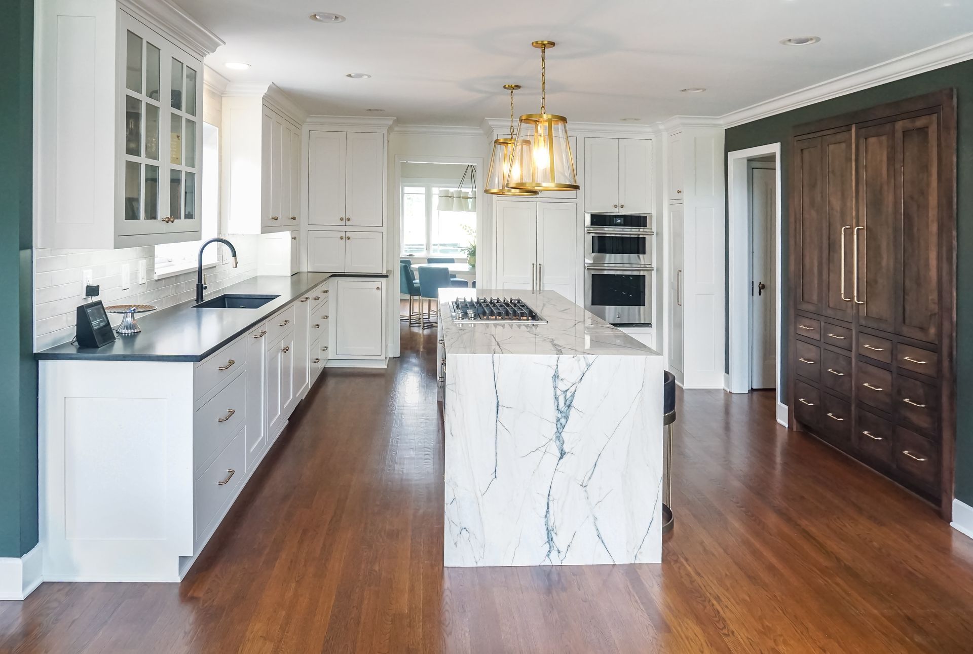 Custom painted wood kitchen cabinets with waterfall style island.