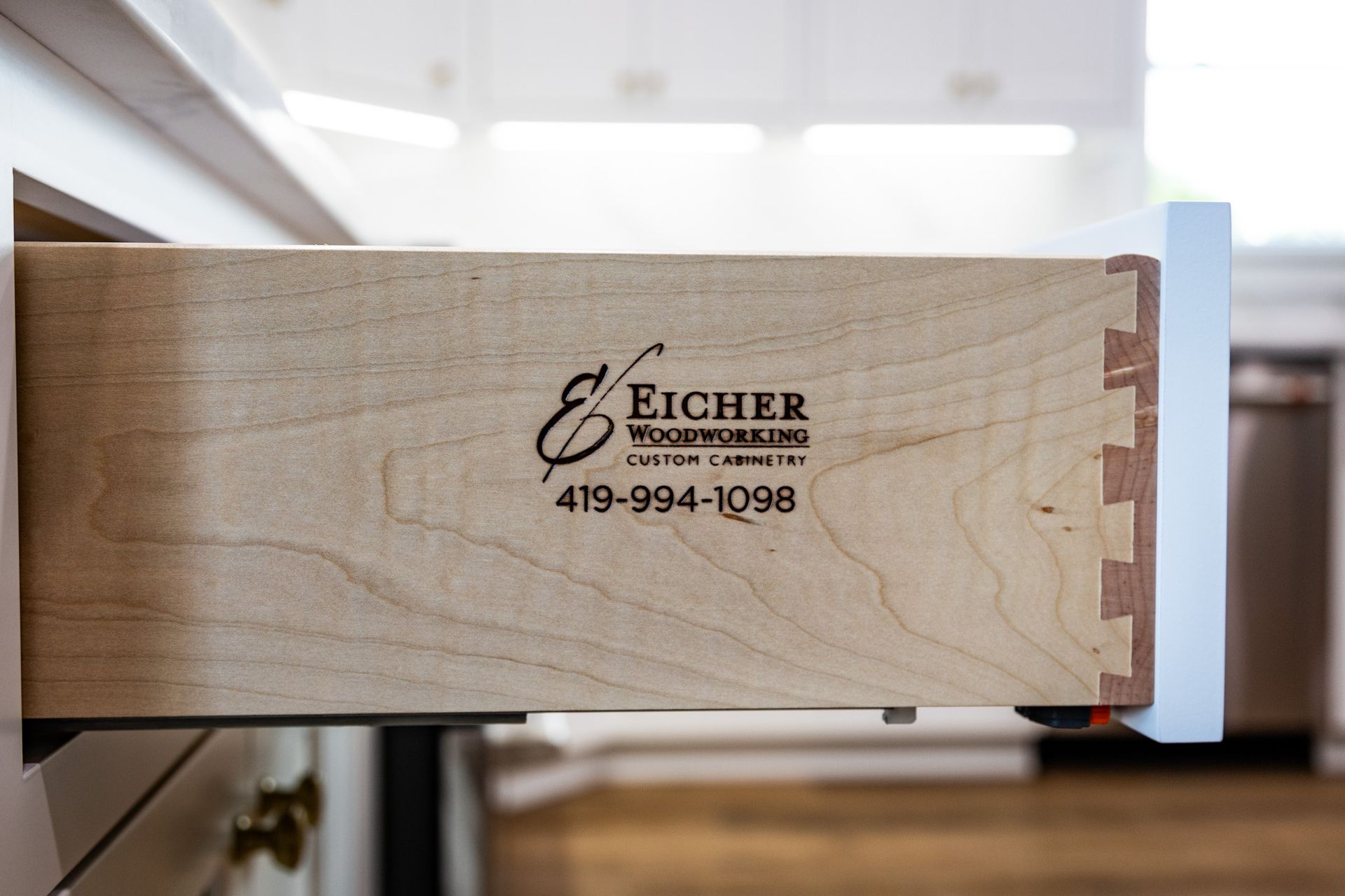 Eicher Woodworking logo on cabinet drawer.
