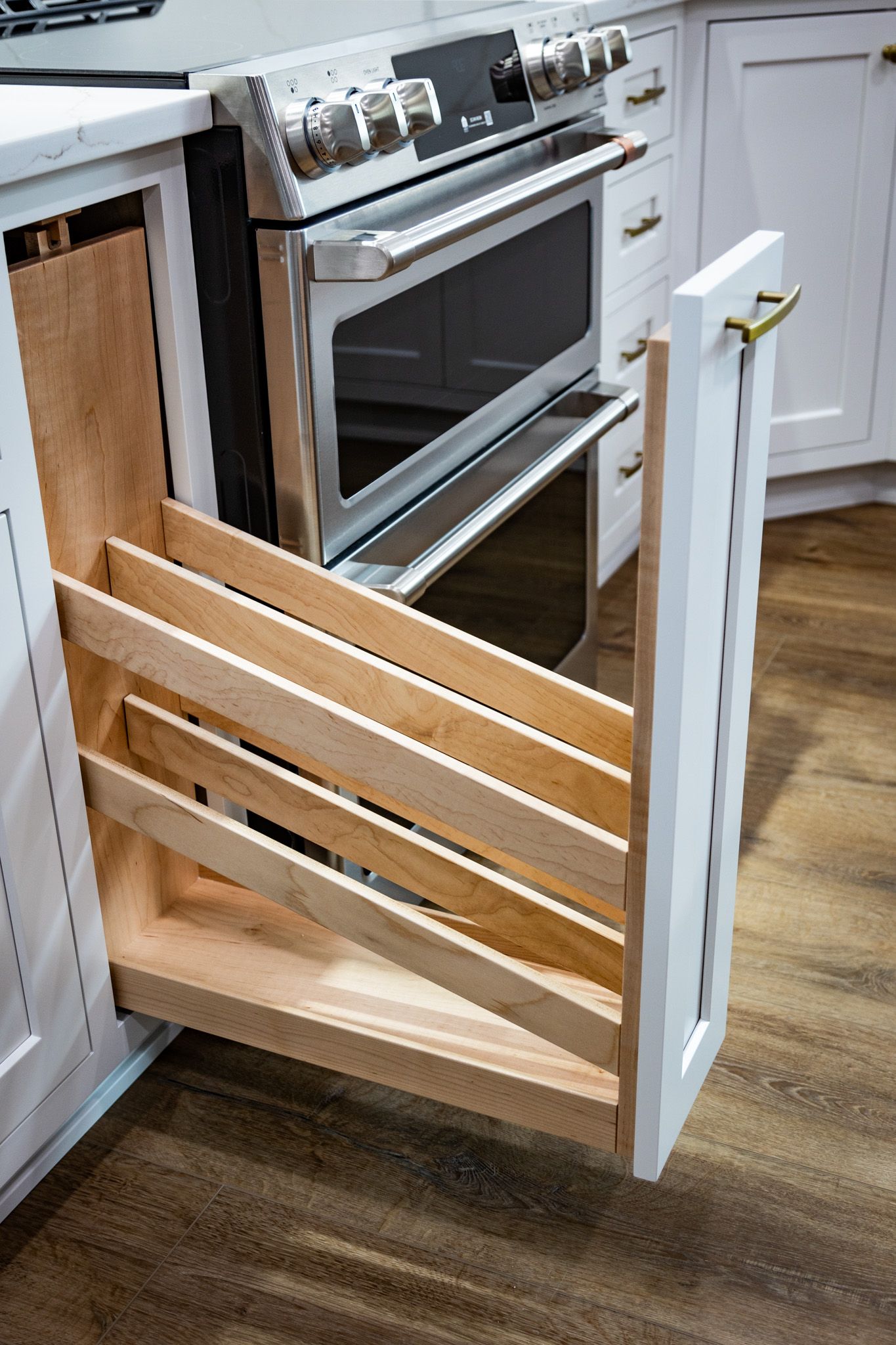 Custom kitchen cabinets with rollout baking sheet organizer.