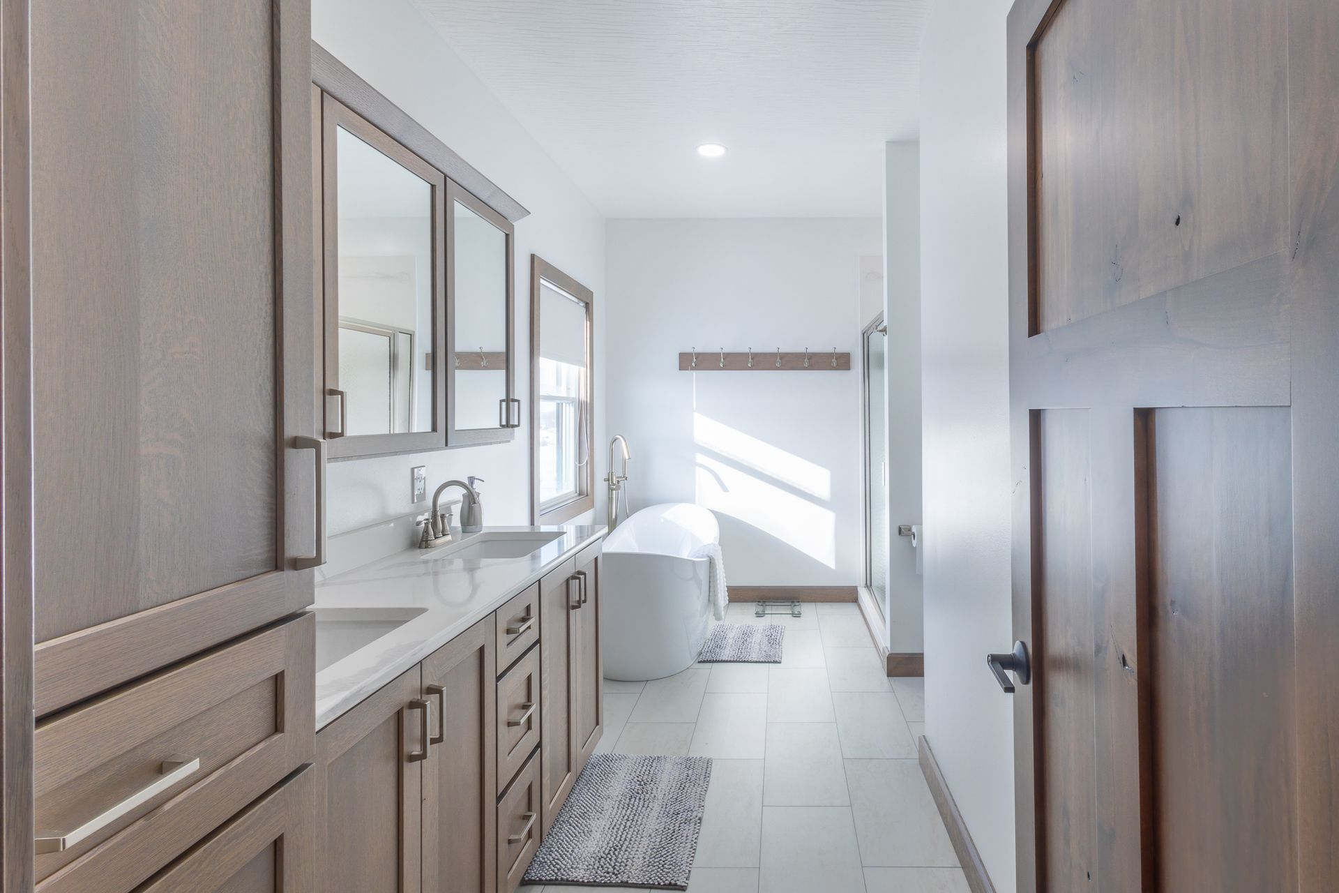 Custom white oak bathroom vanity and linen storage.