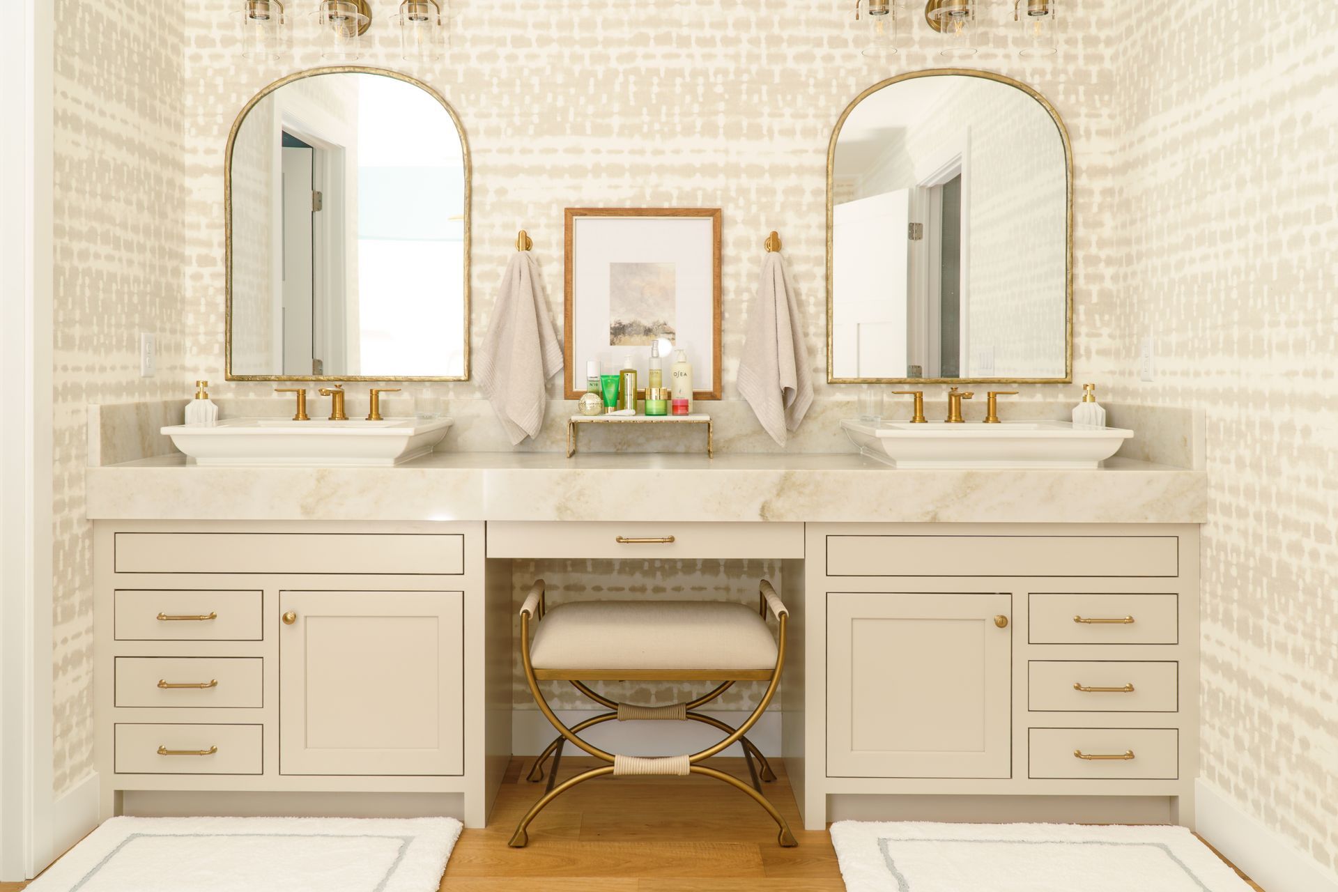 White painted double bathroom vanity with arched top mirrors.