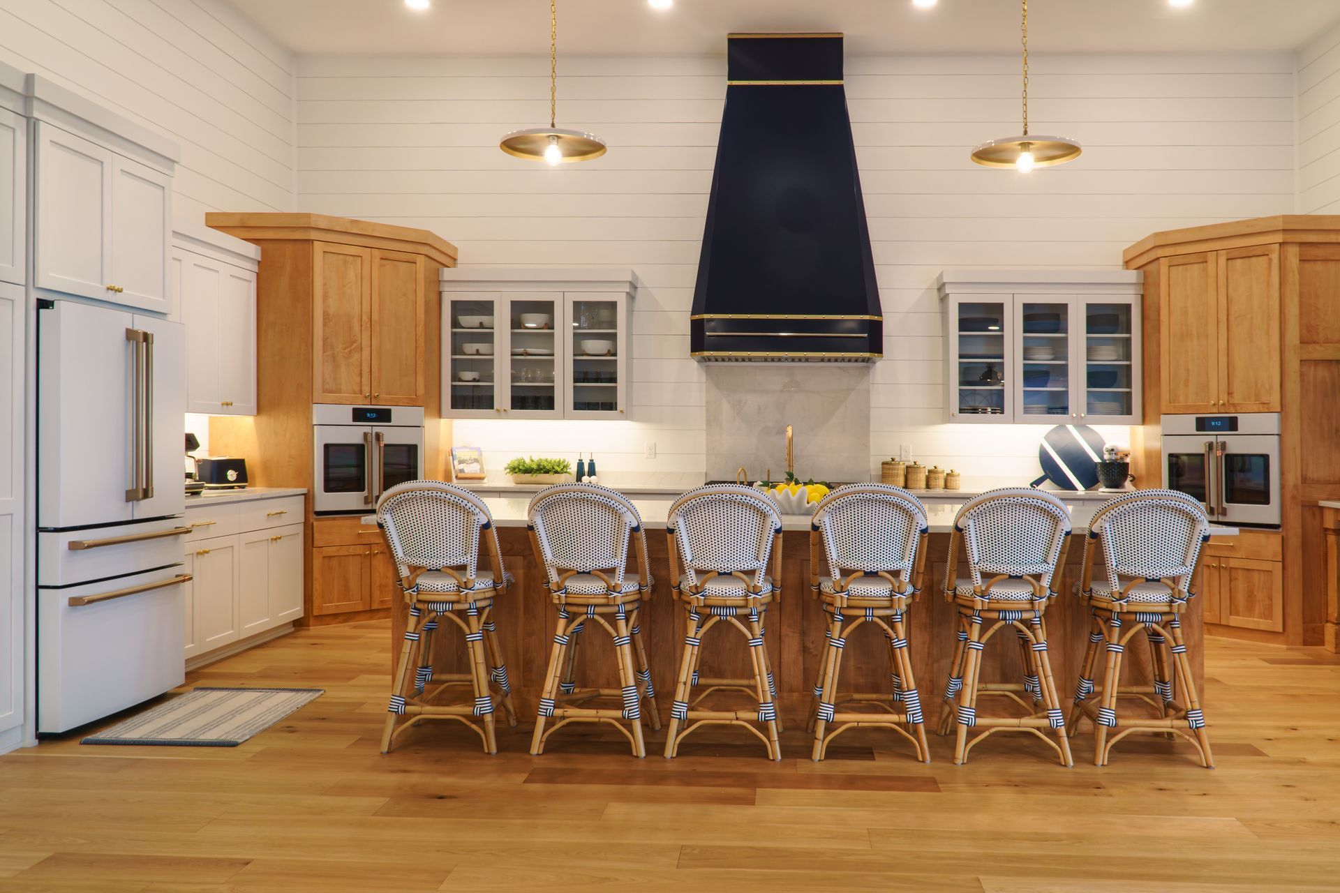 Custom, modern painted kitchen cabinets and stained wood island, stainless appliances and pendant lights.