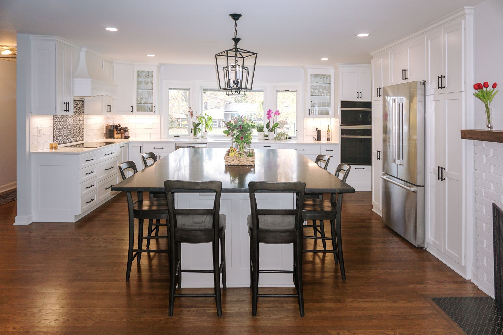 Custom white painted wood kitchen cabinets and island for a modern light look.
