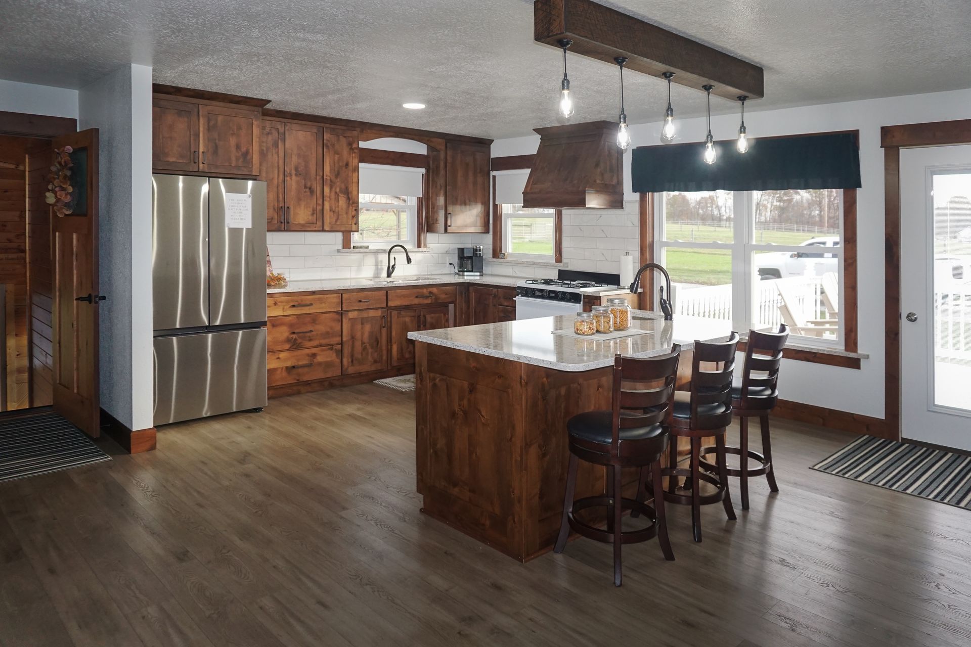 Custom traditional stained wood kitchen cabinets with island.