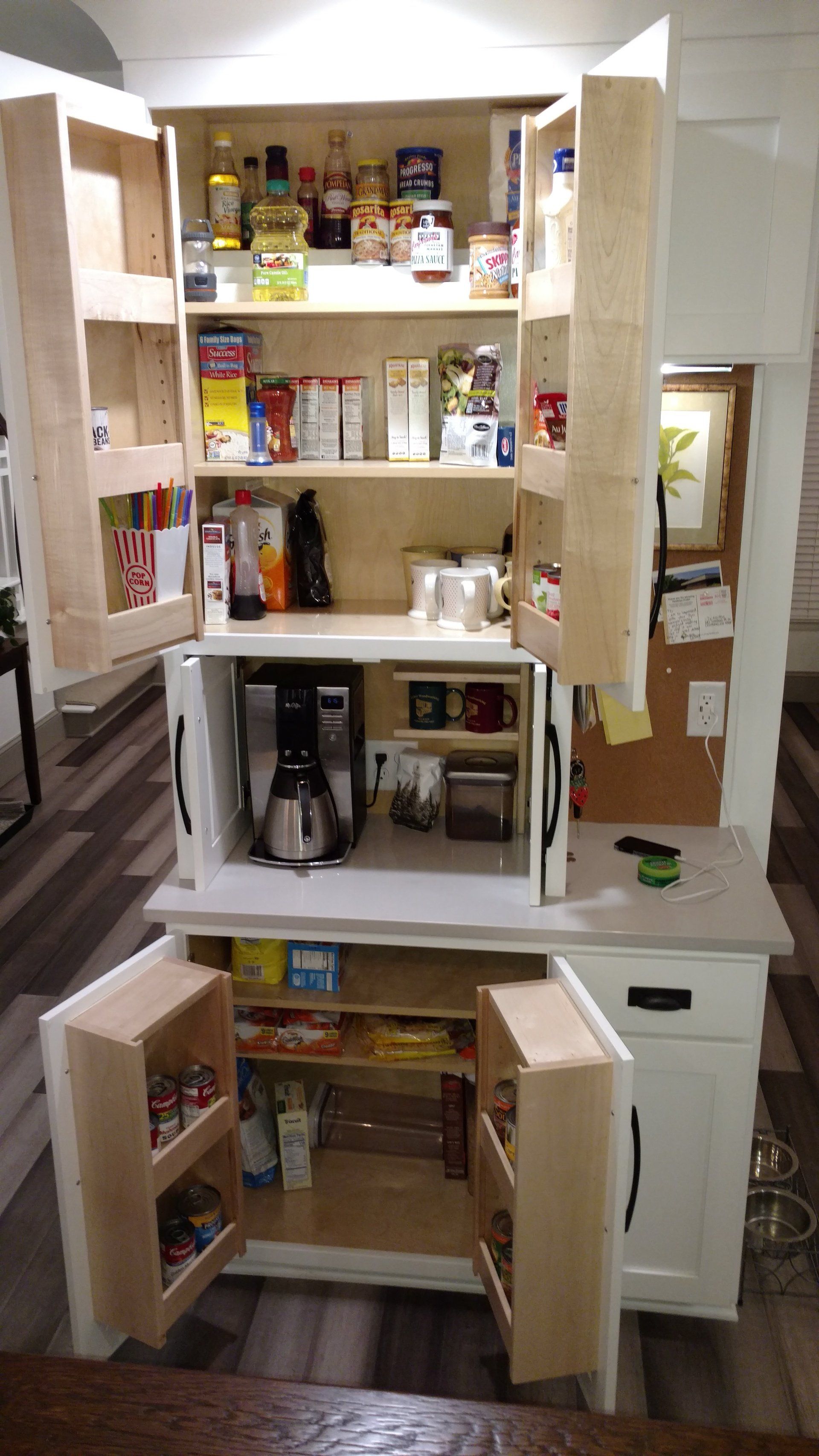 Custom white painted wood beverage, coffee and tea center with upper and base cabinet storage.
