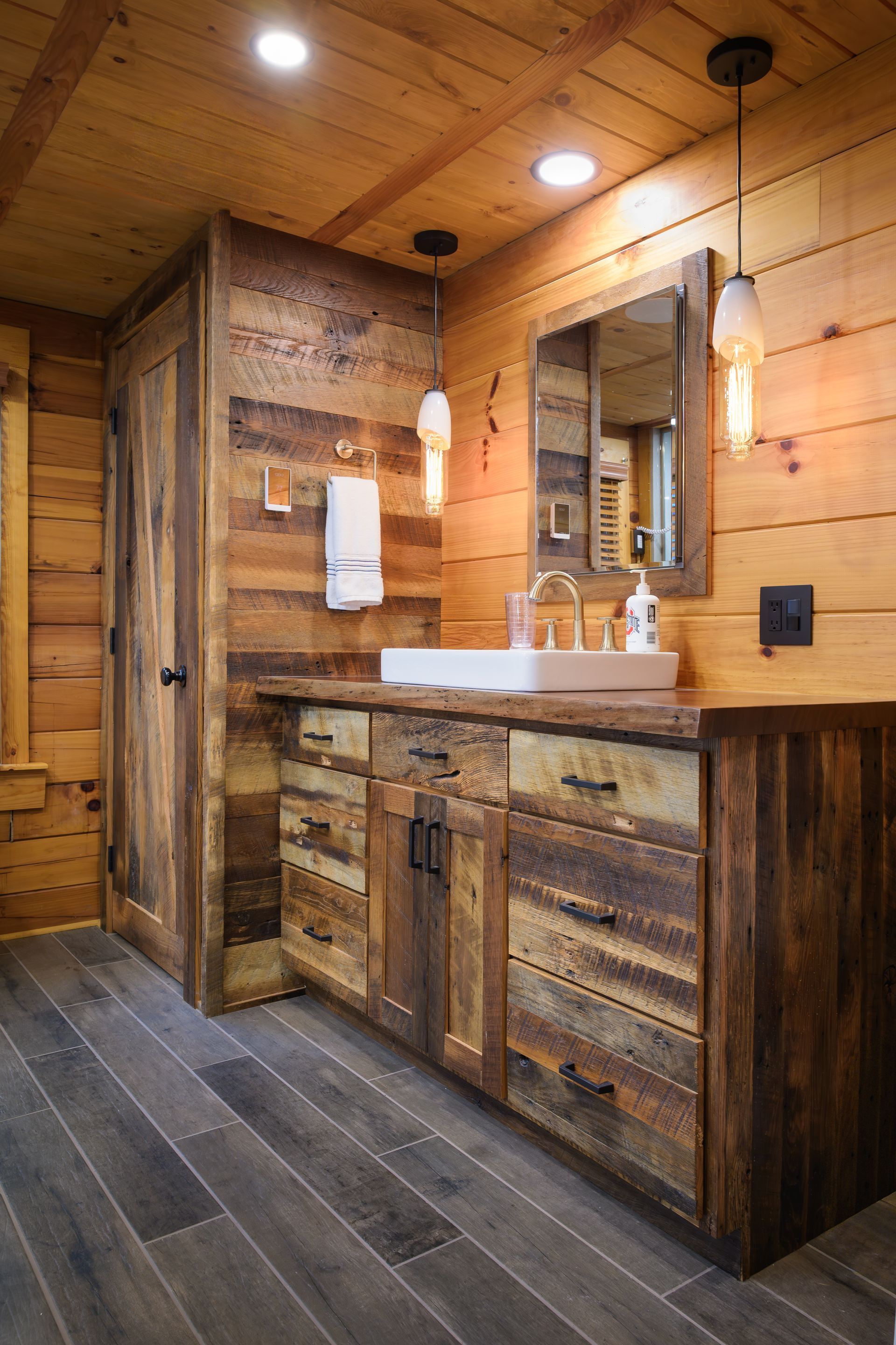 Custom rustic reclaimed barnwood bathroom vanity with rectangular sink.