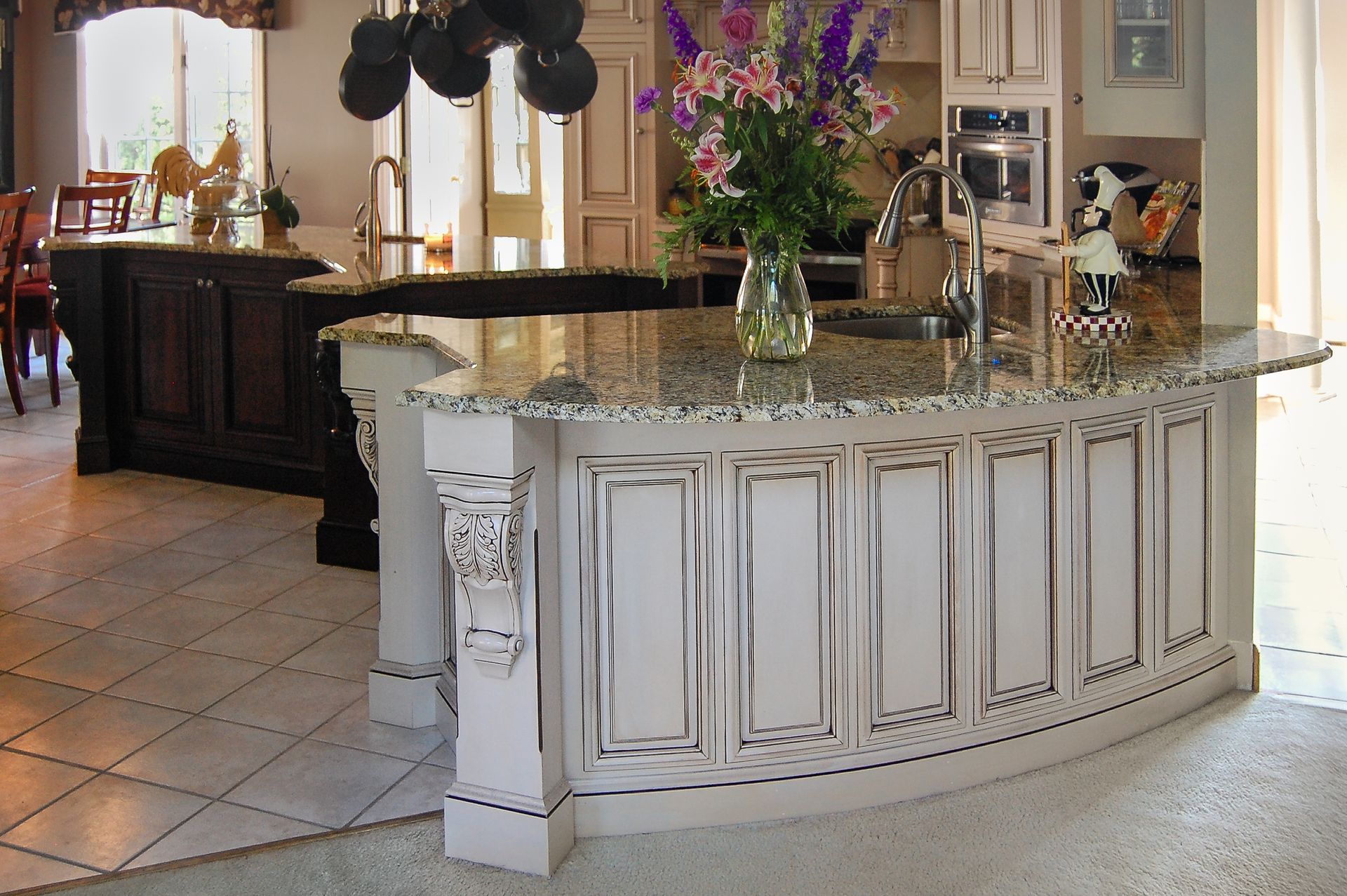 Glazed white kitchen island. Unique curved front with lots of detail and carvings.