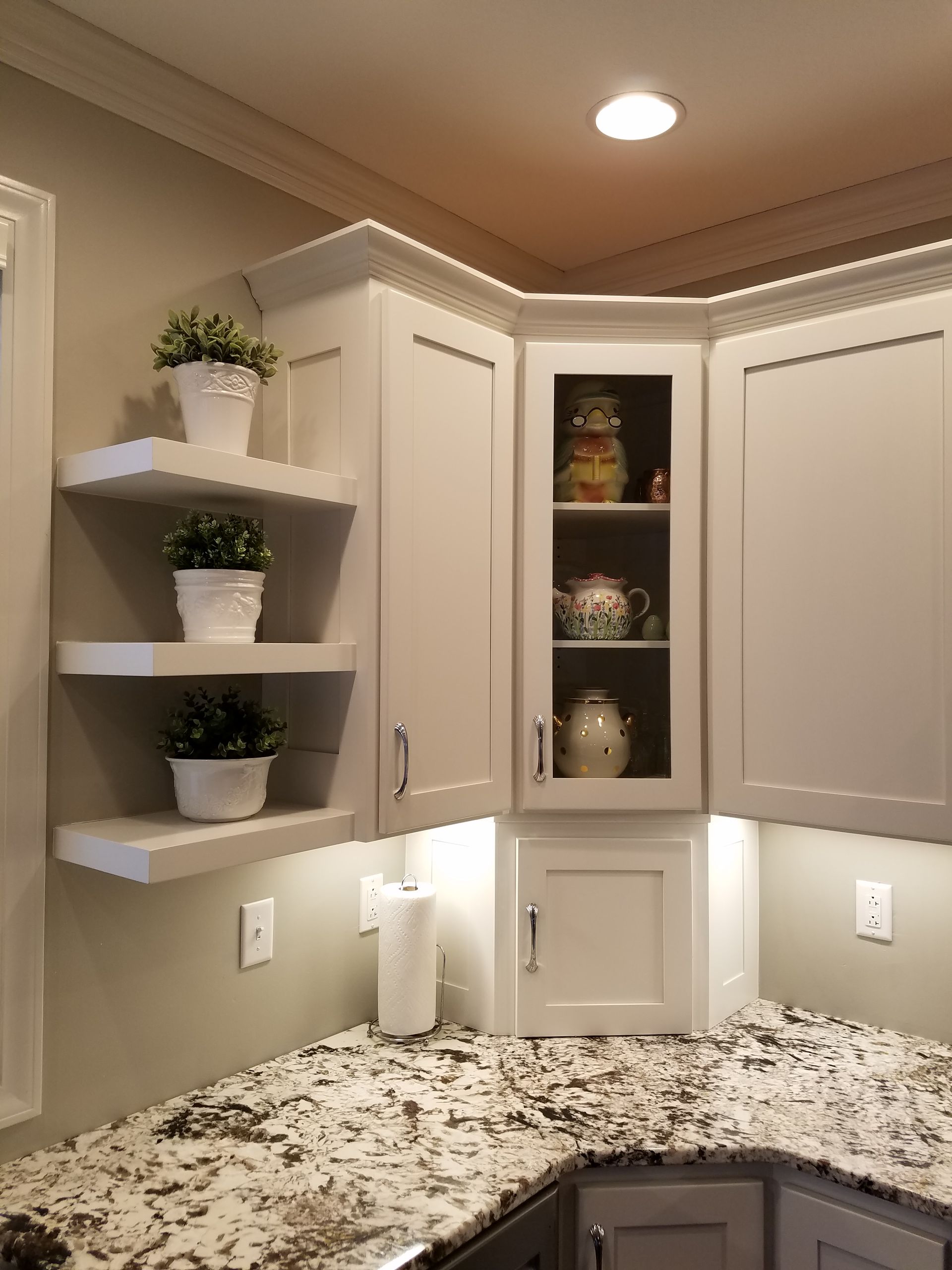 Custom white painted floating shelves.