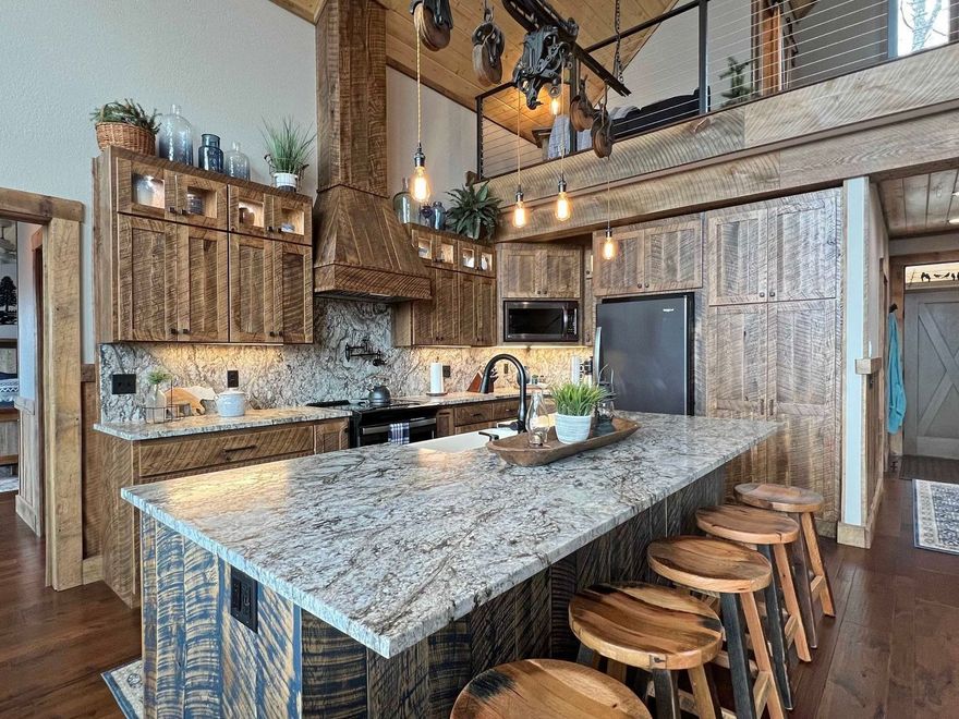 Custom kitchen cabinets, hood & island, rustic rough sawn look.