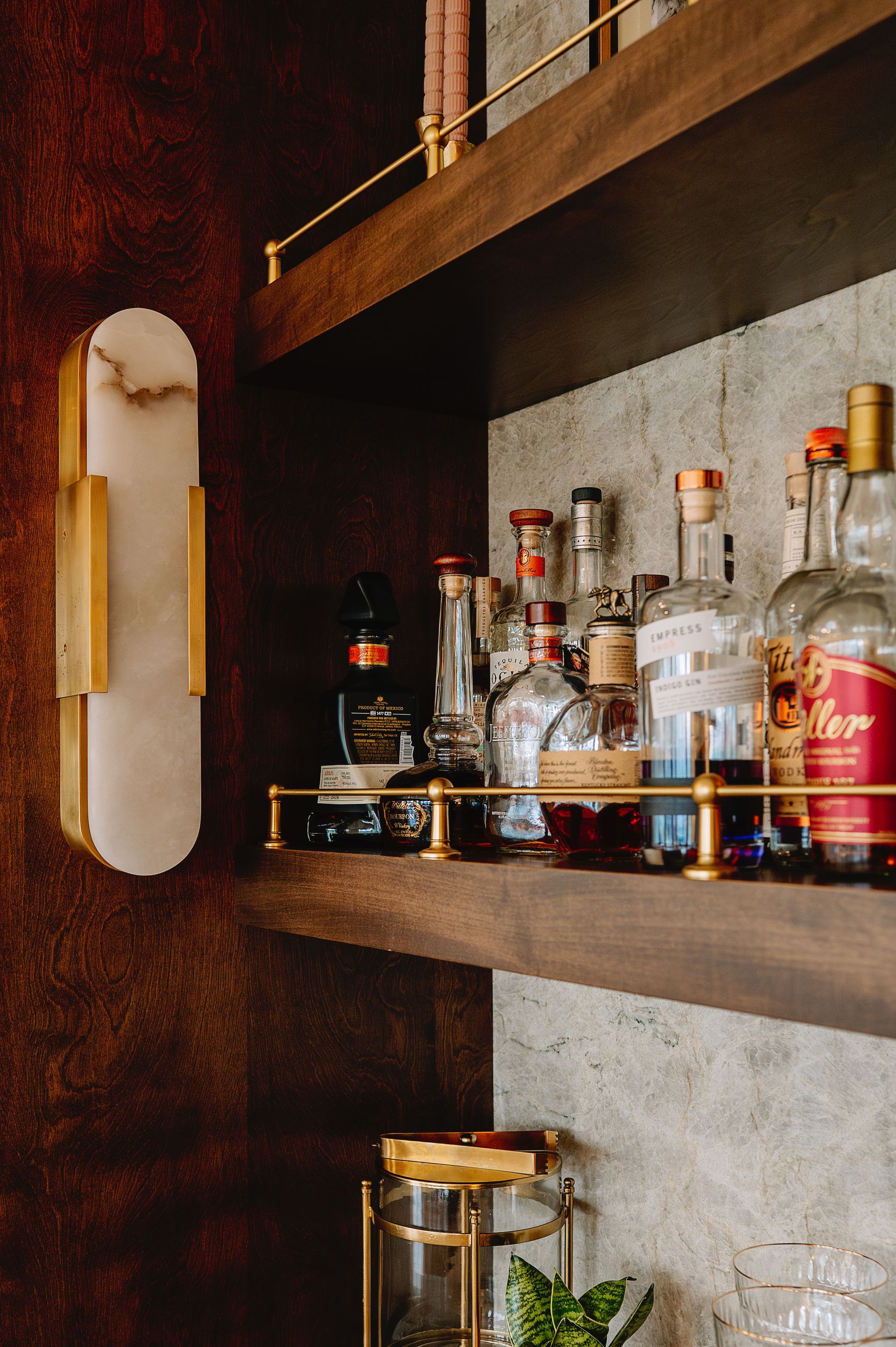 Custom stained wood floating shelf for beverage center.