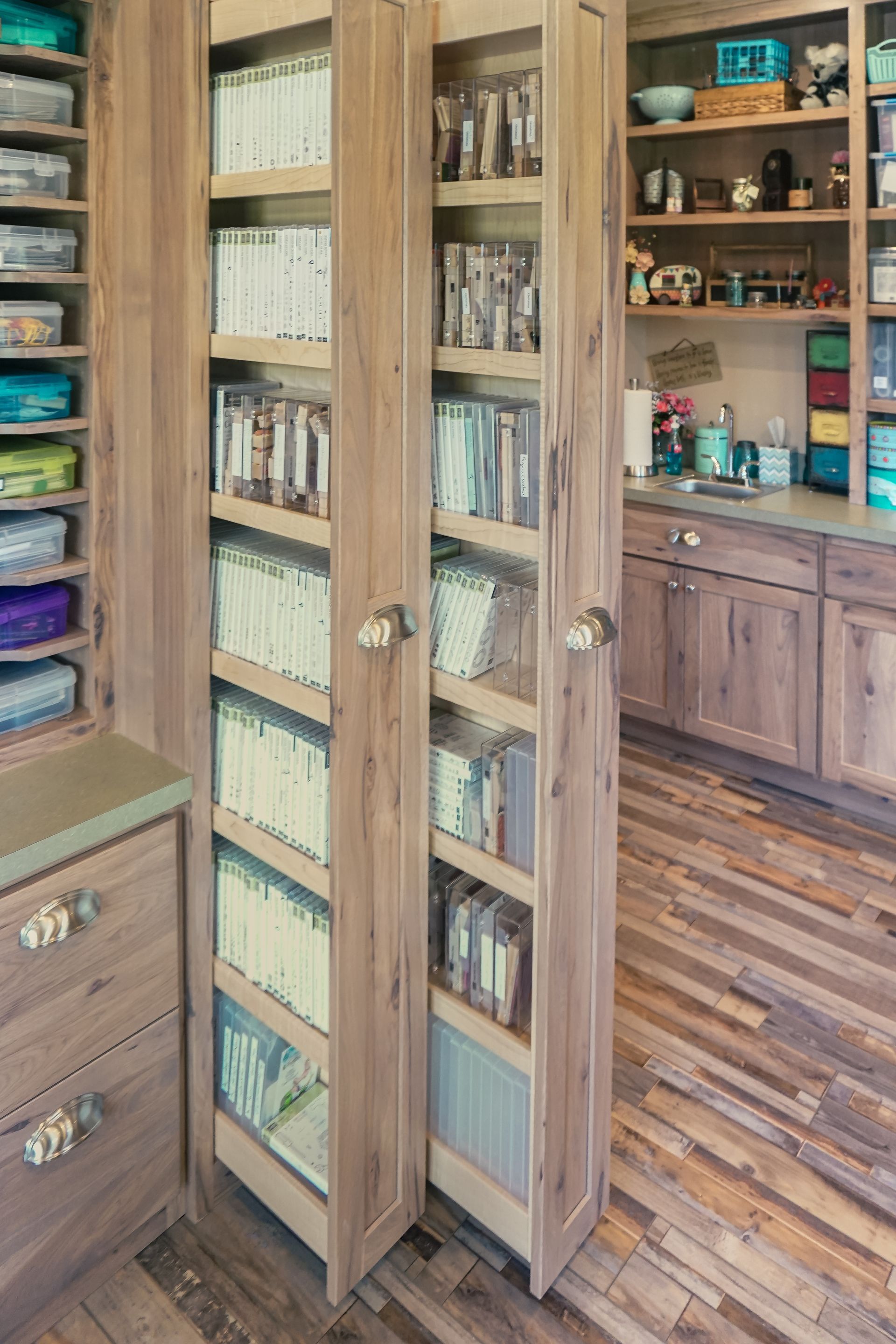 Custom vertical wood pullout storage for crafts, videos and books.