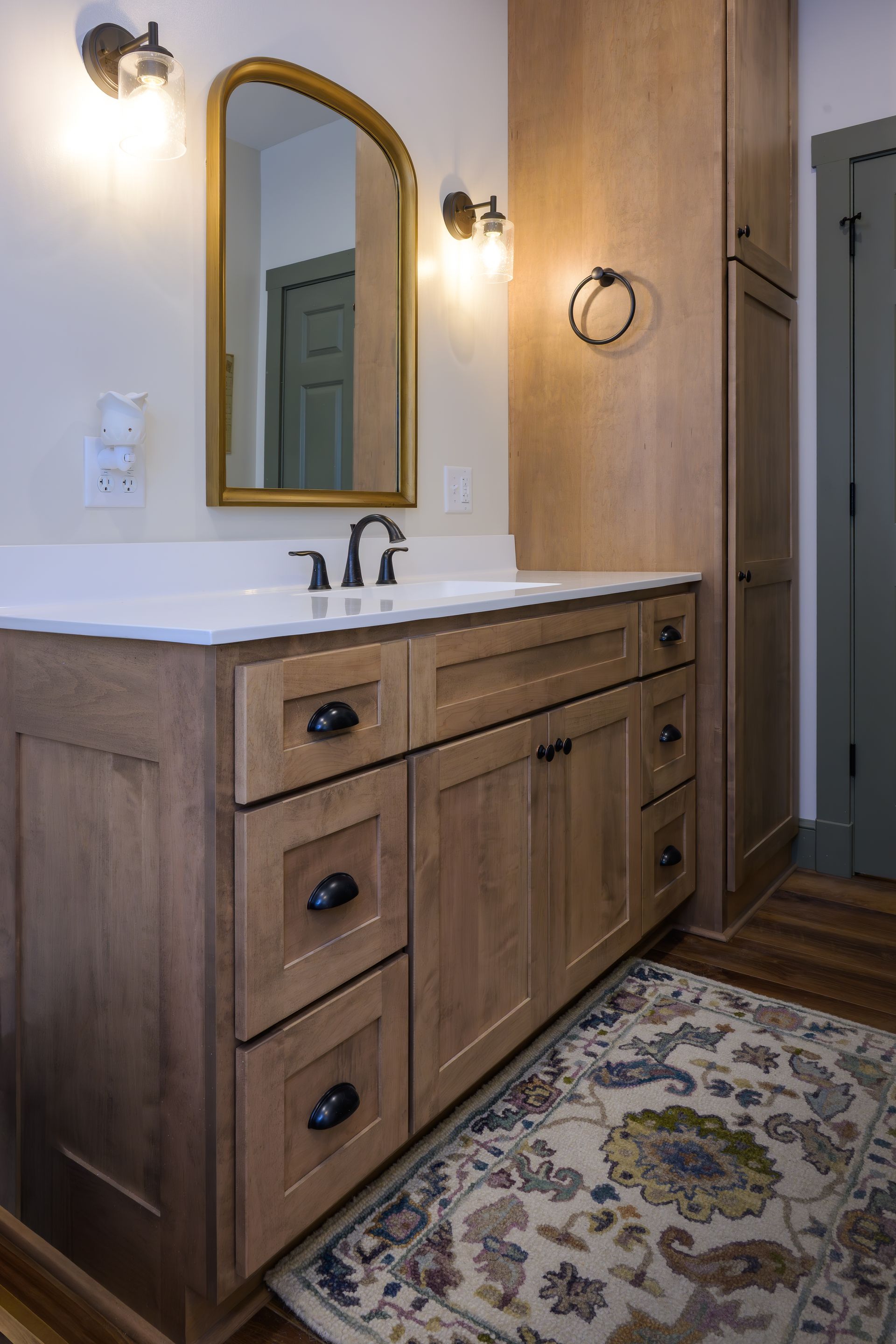 Custom stained wood vanity and linen closet.