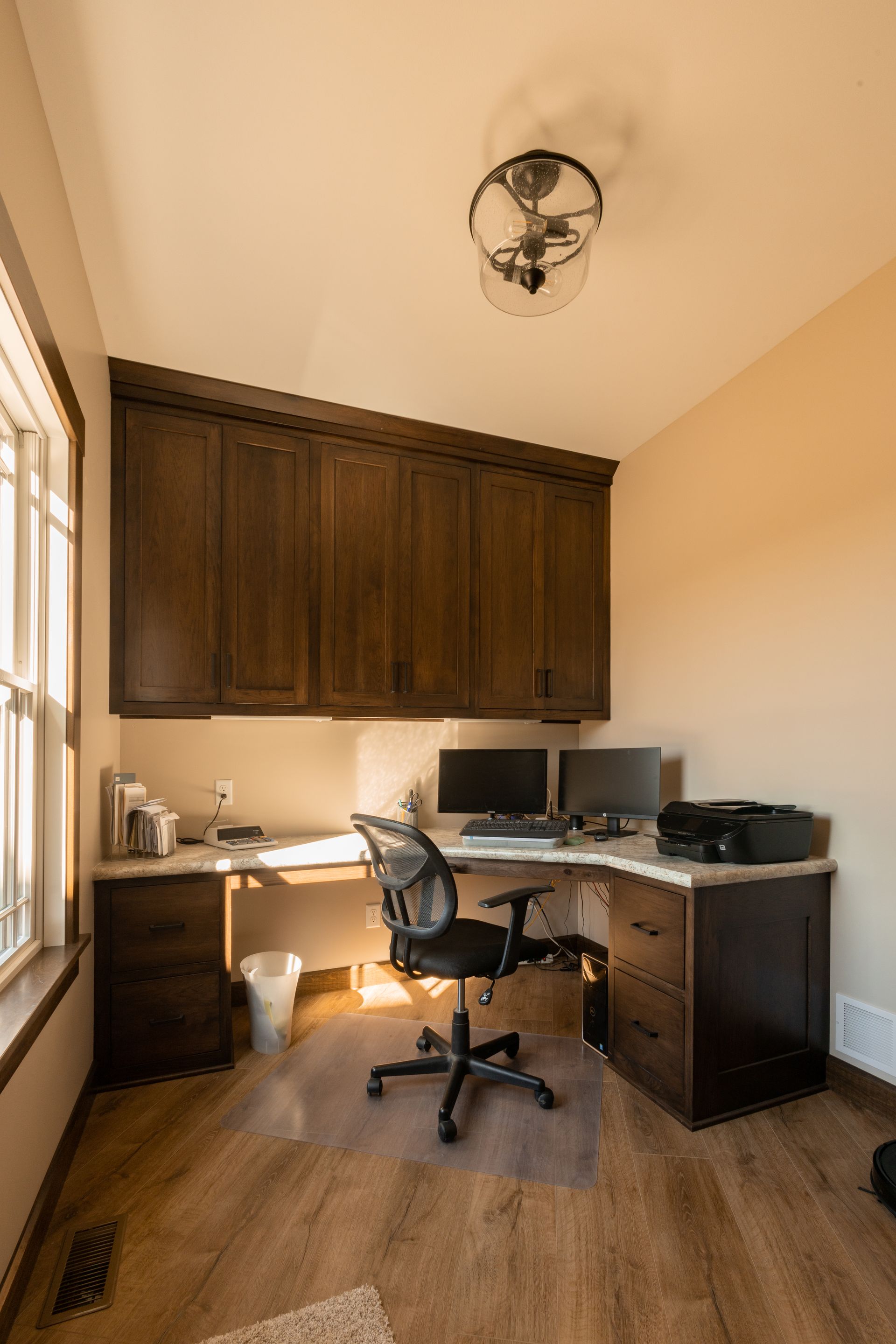 Custom stained wood office space cabinets.