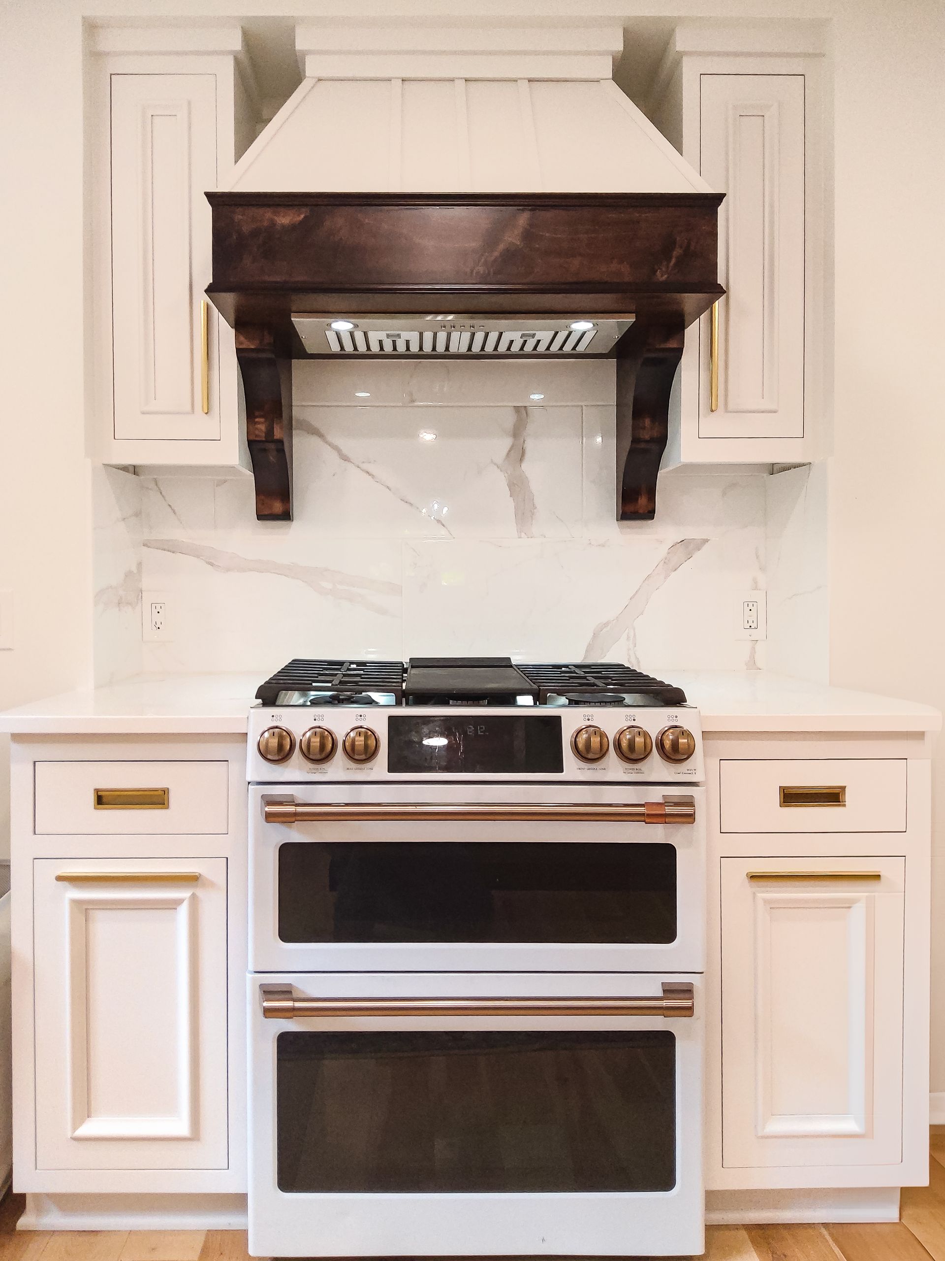 Custom white painted and stained wood range hood.