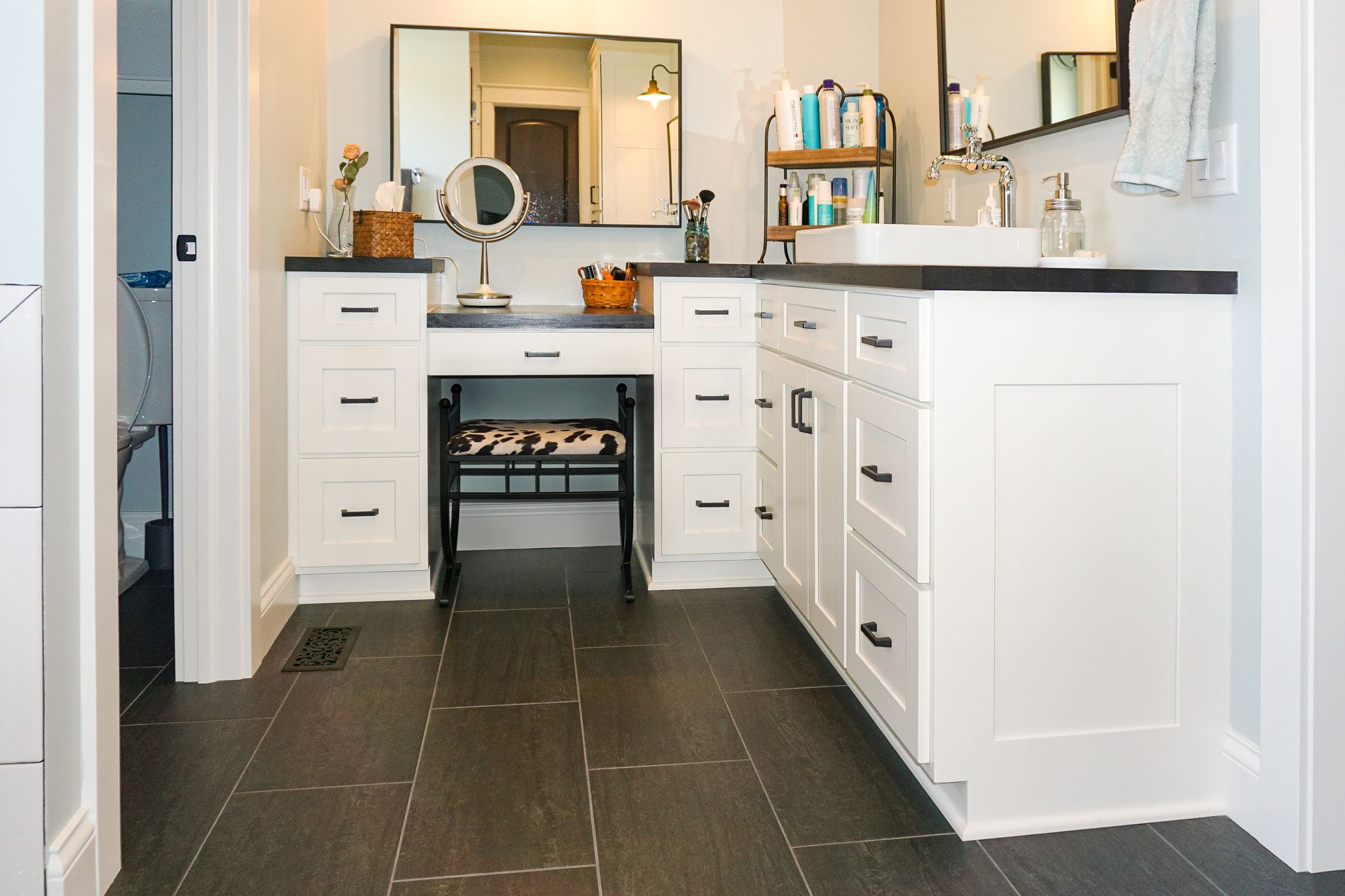 Custom white painted bathroom vanity and makeup station.