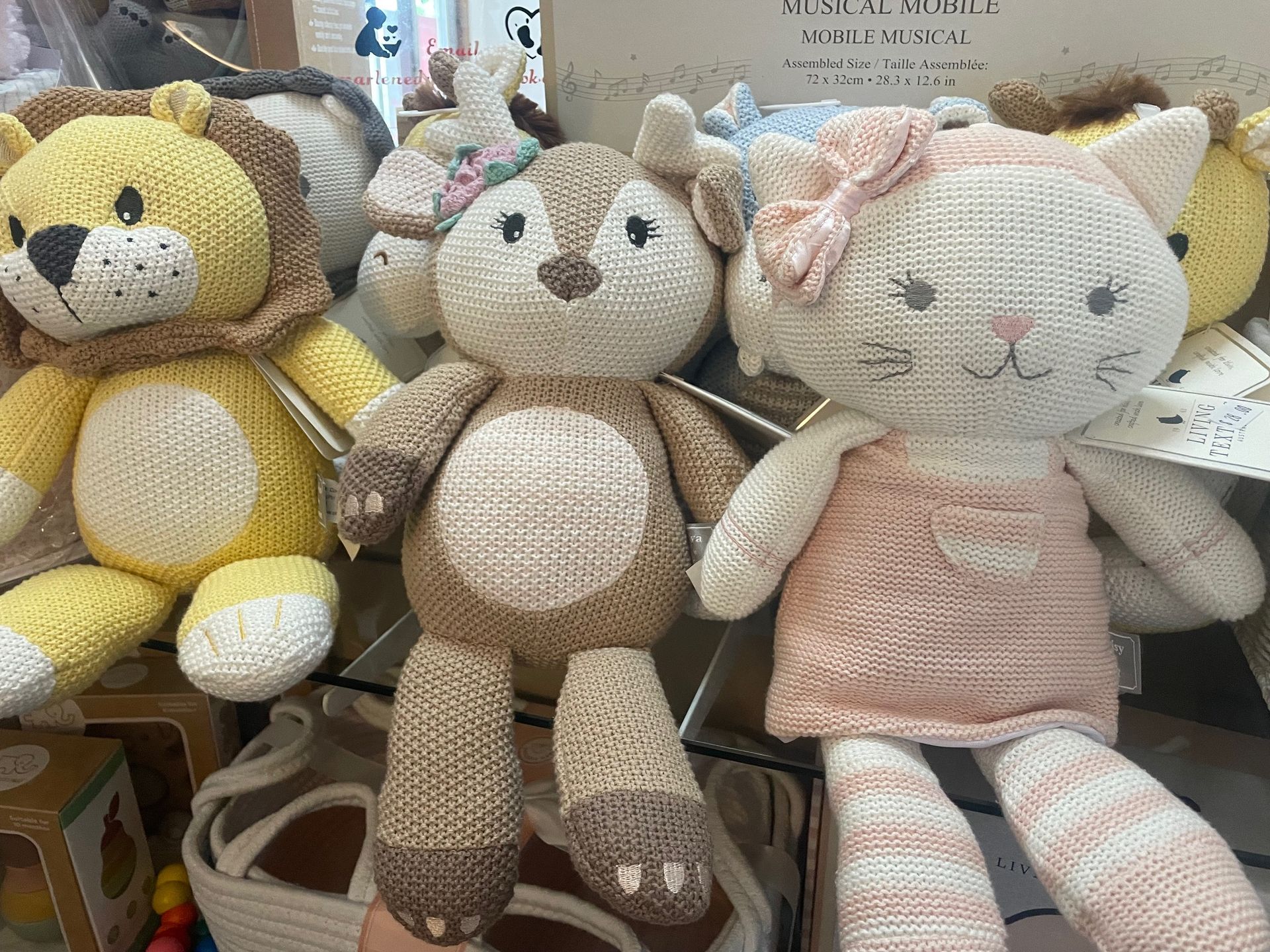 A group of stuffed animals are sitting next to each other on a table.