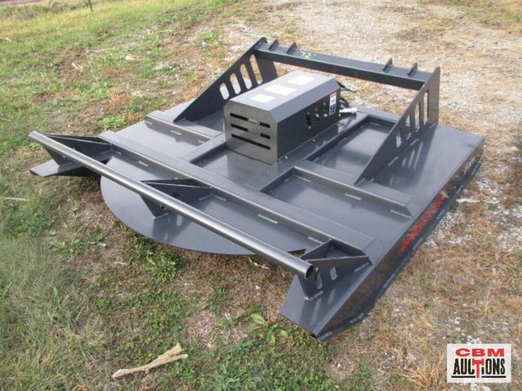 A lawn mower is sitting in the grass at a gdm auction