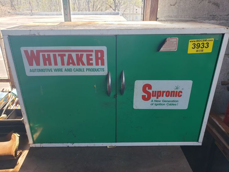 A green cabinet with the word whitaker on it