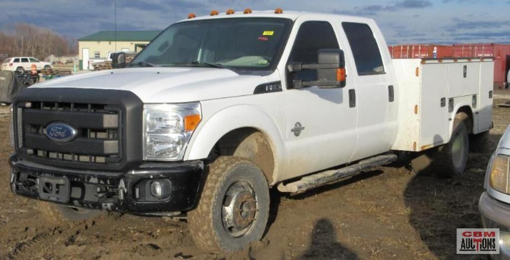 A white ford truck is parked in the dirt