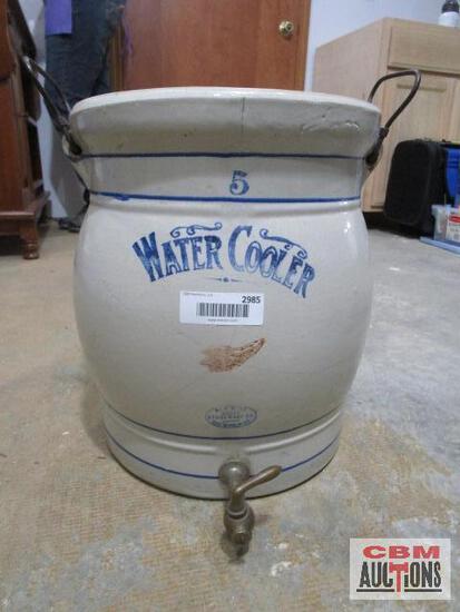 A water cooler with the number 5 on it