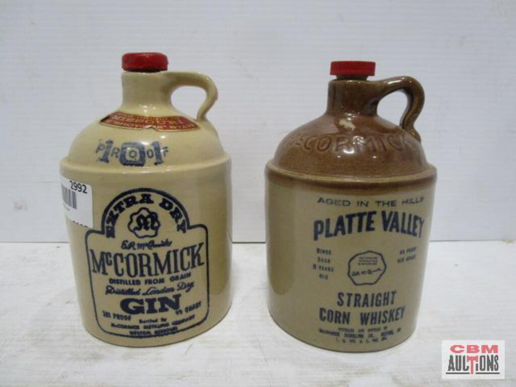 A bottle of mccormick gin sits next to a bottle of platte valley straight corn whiskey