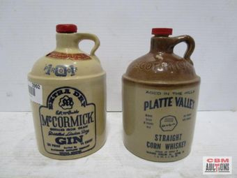A bottle of mccormick gin sits next to a bottle of platte valley straight corn whiskey