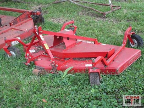 A red lawn mower is sitting in the grass