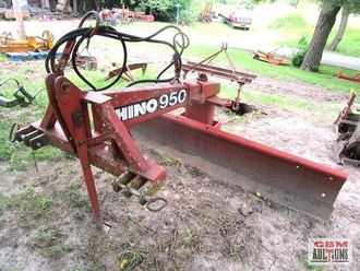 A red rhino950 plow is sitting in the dirt
