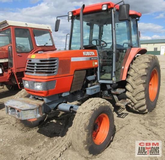 A kubota tractor is parked next to another tractor