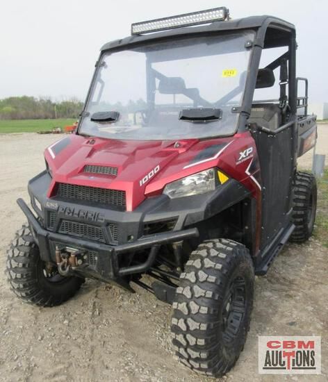 A red and black polaris ranger xp is parked in the dirt