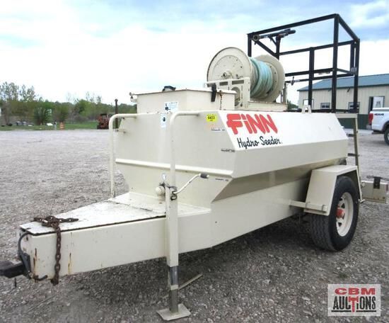 A finn trailer is parked in a gravel lot
