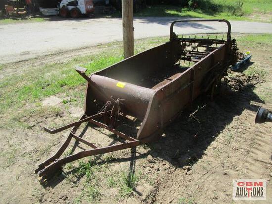 An old wagon is sitting in the dirt next to a road.