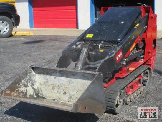 A red and black toro tractor with a large bucket