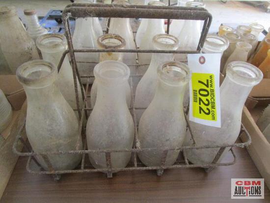 A tray of milk bottles with a tag that says 7022